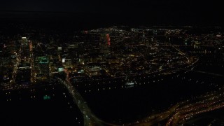AX155_359E - 5.5K aerial stock footage flying by the Downtown Portland cityscape, and bridges over the Willamette River at nighttime