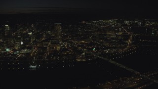 AX155_361 - 5.5K stock footage aerial video of US Bancorp Tower and the White Stag sign across the Willamette River and Burnside Bridge, night, Downtown Portland, Oregon