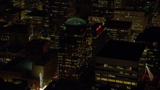 AX155_378 - 5.5K aerial stock footage approaching 1000 Broadway building and Hilton Portland at night in Downtown Portland, Oregon