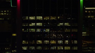 AX155_381E - 5.5K aerial stock footage tracking the top floors of Wells Fargo Center at night in Downtown Portland, Oregon