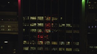 AX155_382 - 5.5K aerial stock footage tracking offices on the top floors of Wells Fargo Center at night in Downtown Portland, Oregon