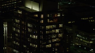AX155_384 - 5.5K aerial stock footage of offices on top floors of Park Avenue West Tower at night in Downtown Portland, Oregon