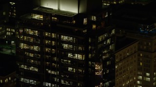 AX155_385 - 5.5K aerial stock footage of the top floors of Park Avenue West Tower at night in Downtown Portland, Oregon