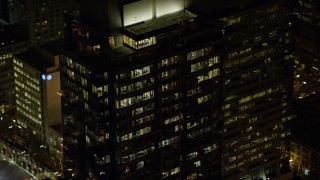 AX155_386 - 5.5K aerial stock footage orbiting the top floors of Park Avenue West Tower at night in Downtown Portland, Oregon