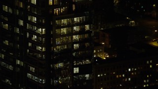 AX155_387 - 5.5K aerial stock footage orbiting the top floors of Park Avenue West Tower at nighttime in Downtown Portland, Oregon