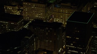 AX155_390 - 5.5K aerial stock footage flying by high-rises to reveal SW 5th Avenue at night in Downtown Portland, Oregon