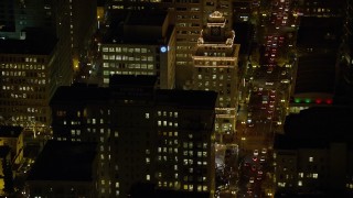 AX155_394E - 5.5K aerial stock footage flying by Jackson Tower and SW Broadway at night in Downtown Portland, Oregon