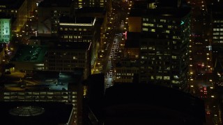 AX155_398 - 5.5K aerial stock footage of city traffic on SW 3rd Avenue at nighttime in Downtown Portland, Oregon