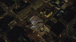 AX155_404 - 5.5K stock footage aerial video orbiting and flying away from Christmas tree in Pioneer Courthouse Square at night in Downtown Portland, Oregon