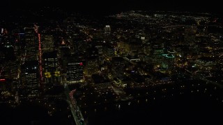 AX155_406E - 5.5K aerial stock footage approaching Downtown Portland from the Willamette River at night in Oregon