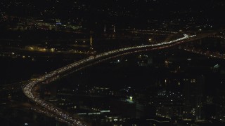 AX155_410 - 5.5K aerial stock footage of heavy traffic on the Fremont Bridge at night in Downtown Portland, Oregon