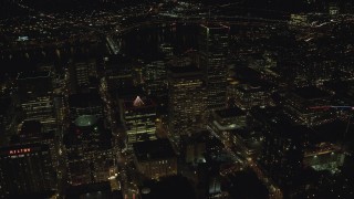 AX155_414 - 5.5K aerial stock footage flying by PacWest Center, SW Jefferson Street, and Wells Fargo Center at night in Downtown Portland, Oregon