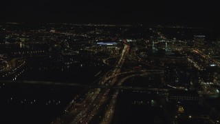 AX155_420 - 5.5K stock footage aerial video following I-5 over interchange to approach Moda Center and convention Center at night in Northeast Portland, Oregon