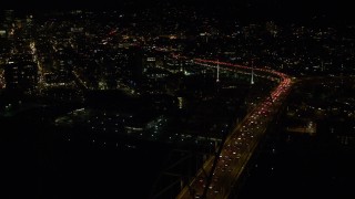 AX155_423E - 5.5K aerial stock footage approach and orbit the Fremont Bridge with heavy traffic on upper deck to reveal Downtown Portland, Oregon