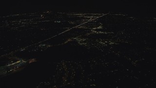 AX155_444 - 5.5K aerial stock footage approaching apartment complex and suburban homes by Highway 26 at night, Beaverton, Oregon