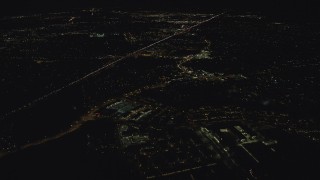 AX155_445 - 5.5K aerial stock footage flying over apartment complex toward strip malls and suburban homes by Highway 26 at night, Beaverton, Oregon