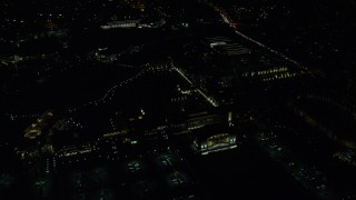 AX155_448E - 5.5K aerial stock footage flying by Nike Headquarters office buildings at night, Beaverton, Oregon