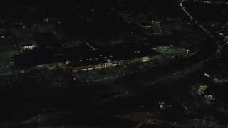 AX155_451 - 5.5K aerial stock footage orbiting the Washington Square shopping mall at night in Tigard, Oregon