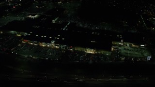AX155_451E - 5.5K aerial stock footage orbiting the Washington Square shopping mall at night in Tigard, Oregon
