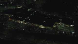 AX155_452 - 5.5K aerial stock footage orbiting the Washington Square shopping mall at night in Tigard, Oregon