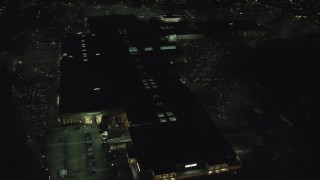 AX155_453 - 5.5K aerial stock footage orbiting the Washington Square shopping mall at night in Tigard, Oregon