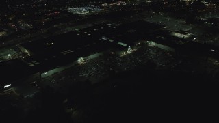 AX155_454 - 5.5K aerial stock footage orbiting the side of Washington Square shopping mall at night in Tigard, Oregon