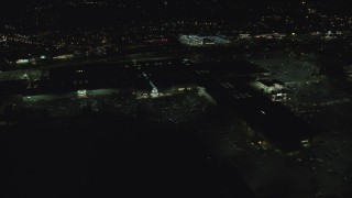AX155_455 - 5.5K aerial stock footage orbiting side of Washington Square mall at night in Tigard, Oregon