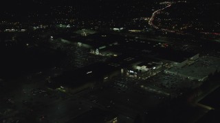 AX155_456 - 5.5K aerial stock footage orbiting the side of Washington Square mall at nighttime in Tigard, Oregon