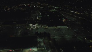 AX155_457 - 5.5K aerial stock footage orbiting around the side of Washington Square mall at nighttime in Tigard, Oregon