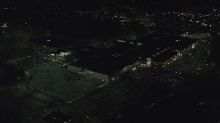 AX155_458 - 5.5K aerial stock footage orbiting around Washington Square mall at nighttime in Tigard, Oregon