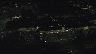 AX155_459 - 5.5K aerial stock footage orbiting around Washington Square shopping mall at nighttime in Tigard, Oregon
