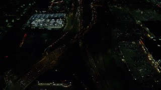 AX155_460 - 5.5K aerial stock footage of and tilt to the interchange of Highways 210 and 217 at night, Beaverton, Oregon