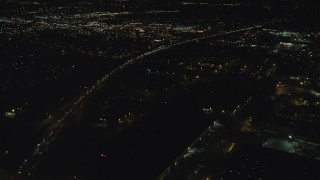 AX155_464 - 5.5K aerial stock footage flying over warehouse buildings, approach Highway 217 and Beaverton Town Square at night, Beaverton, Oregon