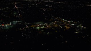 AX155_467 - 5.5K aerial stock footage approaching and tilt to stores on SW Cedar Hills Boulevard at night, Beaverton, Oregon