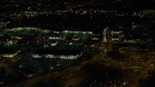 AX155_472 - 5.5K aerial stock footage flying by a busy strip mall at night in Hillsboro, Oregon