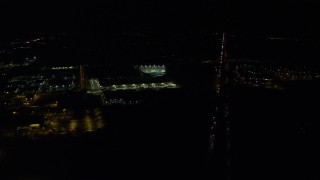 AX155_474 - 5.5K aerial stock footage following Highway 26 to approach a warehouse building and Topgolf course in Hillsboro, Oregon at nighttime
