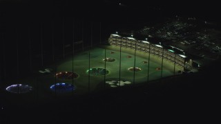 AX155_476 - 5.5K aerial stock footage slowly flying by a Topgolf course in Hillsboro, Oregon at night