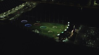 AX155_477 - 5.5K aerial stock footage orbiting a Topgolf course in Hillsboro, Oregon at night