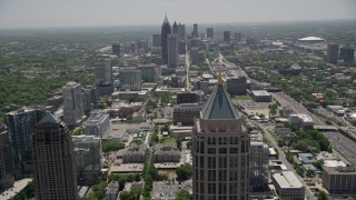 AX36_015E - 4.8K aerial stock footage flying by tops of high-rises, tilt revealing Midtown and Downtown Atlanta skyscrapers, Georgia