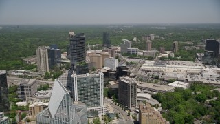 AX36_068E - 4.8K aerial stock footage flying by skyscrapers and office buildings toward a shopping center, Buckhead, Georgia
