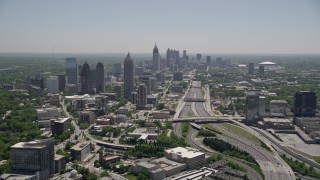 AX36_085E - 4.8K aerial stock footage following Downtown Connector toward Midtown Atlanta skyscrapers, Georgia