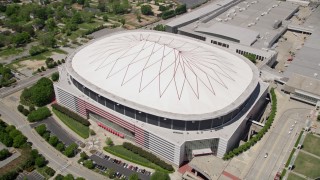 AX36_104 - 4.8K aerial stock footage tilting down on Georgia Dome, Downtown Atlanta