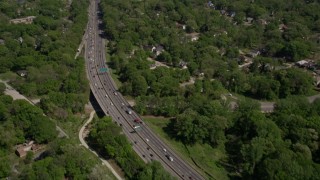 AX37_007 - 4.8K aerial stock footage of light traffic on a freeway tilt up revealing residential area, West Atlanta