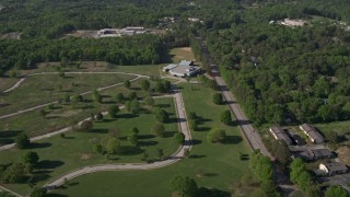 AX38_002 - 4.8K aerial stock footage flying by a rural elementary school nestled among trees, Atlanta, Georgia