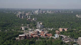 AX38_007 - 4.8K aerial stock footage of a wide shot of skyscrapers and high-rises surrounded by forests, Buckhead, Georgia