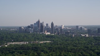 AX38_028 - 4.8K aerial stock footage of Midtown Atlanta skyscrapers  beyond trees, Buckhead, Georgia