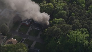AX38_040E - 4.8K aerial stock footage circling black smoke from a burning home, West Atlanta, Georgia