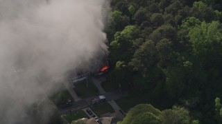AX38_045E - 4.8K aerial stock footage of smoke rising from a burning house, West Atlanta, Georgia