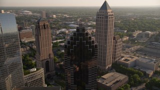 AX39_025 - 4.8K aerial stock footage flying away from Promenade II revealing cluster of skyscrapers, Midtown Atlanta