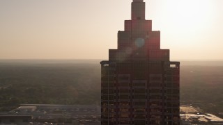 AX39_038 - 4.8K aerial stock footage orbiting top of SunTrust Plaza, Downtown Atlanta, sunset